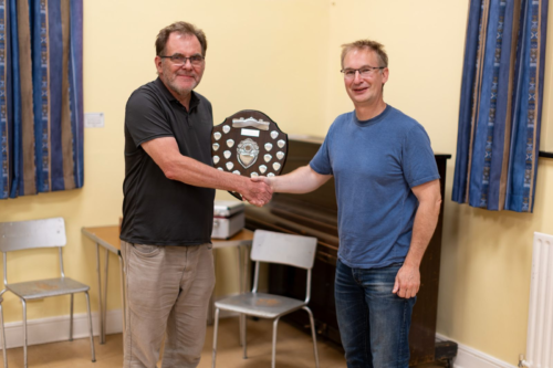 2025 Club Championship winner Simon Foster is presented with the trophy by Club Secretary Nigel Smith