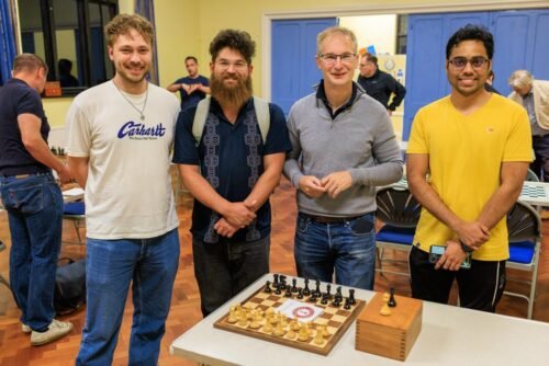 Four of our members with the chess set kindly donated by Regency Chess