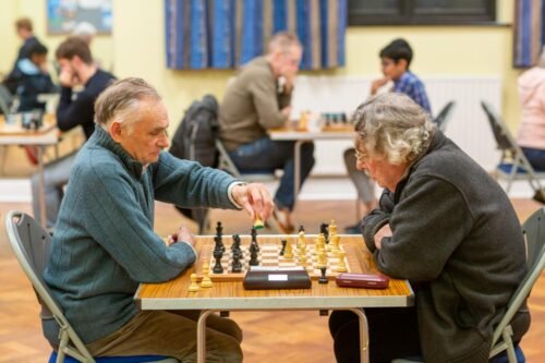 Two members playing a game at Maidenhead Chess Club, one making a move